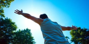 Person stretching in sunny park
